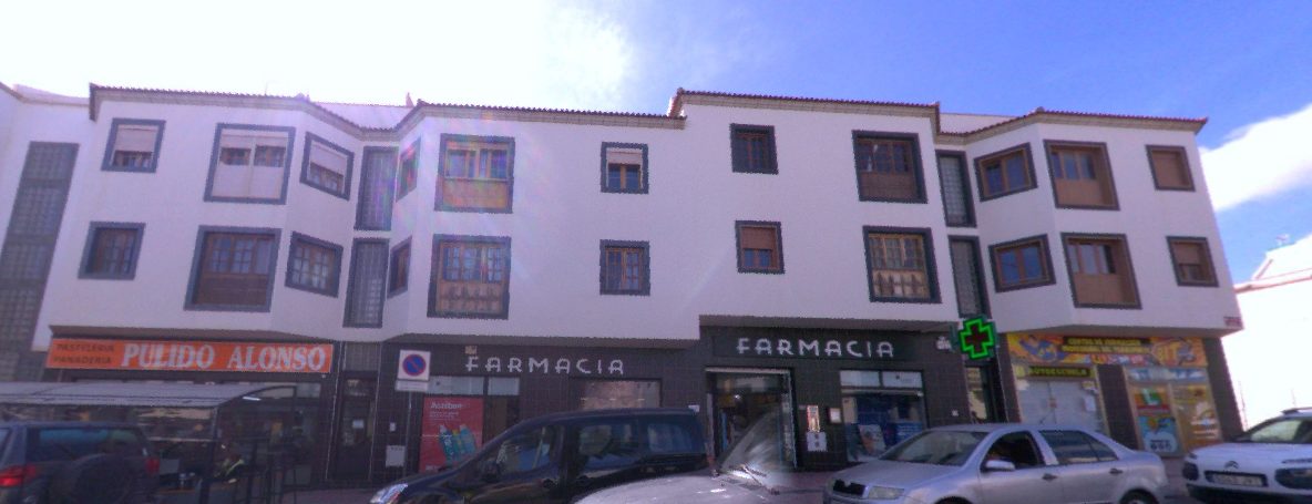 Reference photograph of the same commercial facade
